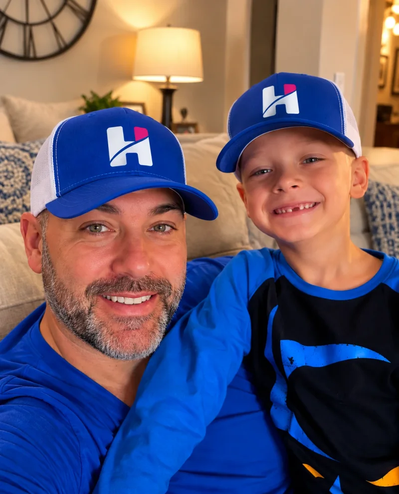 Founder Chase Turner and his son Hank, both wearing Hank's Carpet Cleaning hats