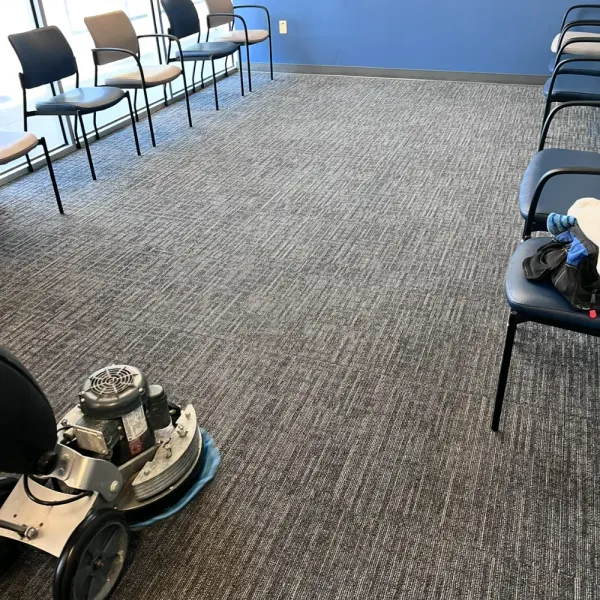 Waiting room carpet being cleaned with a low-moisture carpet machine