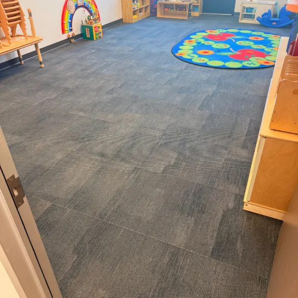 Clean carpet tiles in a daycare classroom