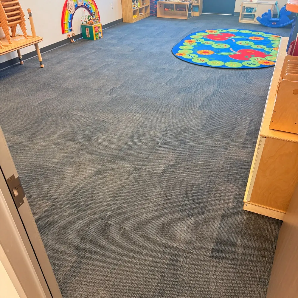 Clean carpet tiles in a daycare classroom