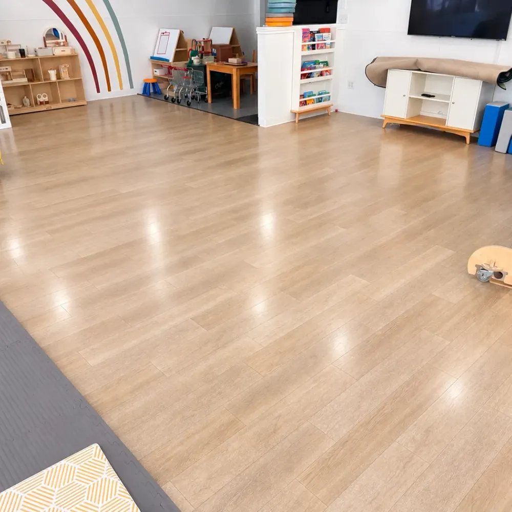 Daycare play room with shiny, clean vinyl plank floors after commercial floor cleaning