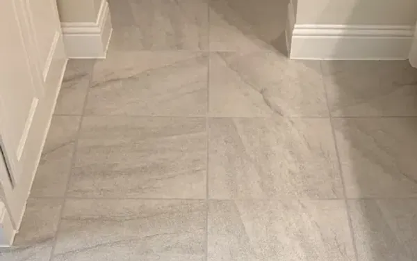 Hallway tile with evenly colored grout after grout color sealing