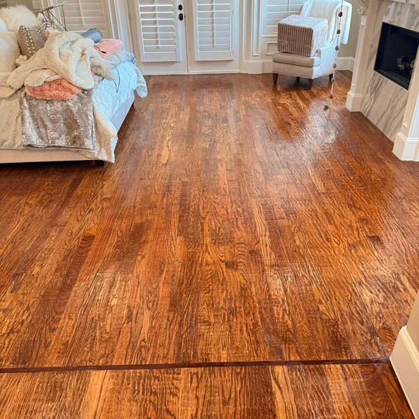 Glossy hardwood bedroom floor after a Hank's cleaning and buffing