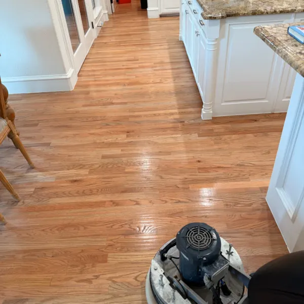 Kitchen hardwood floor being buffed