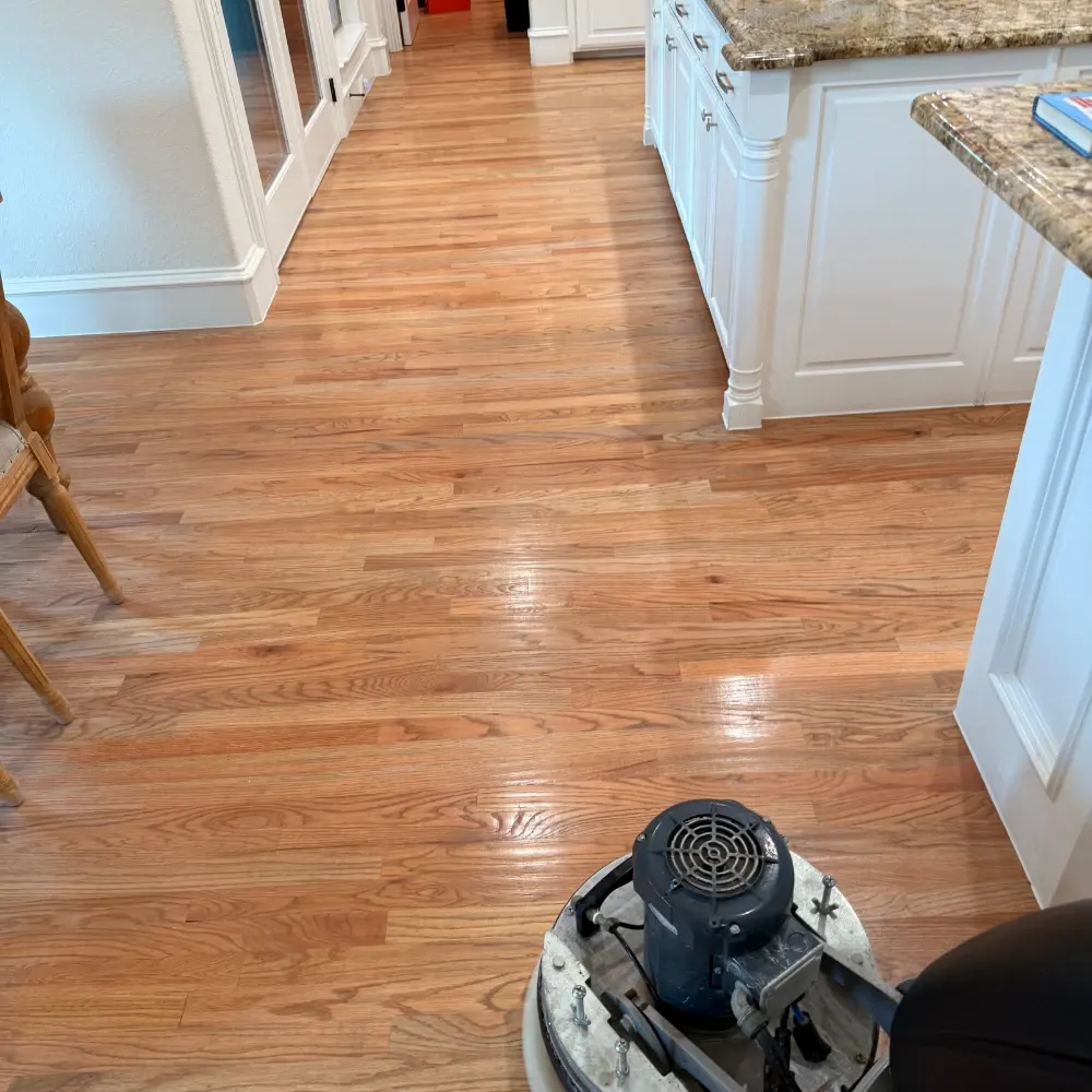 Kitchen hardwood floor being buffed