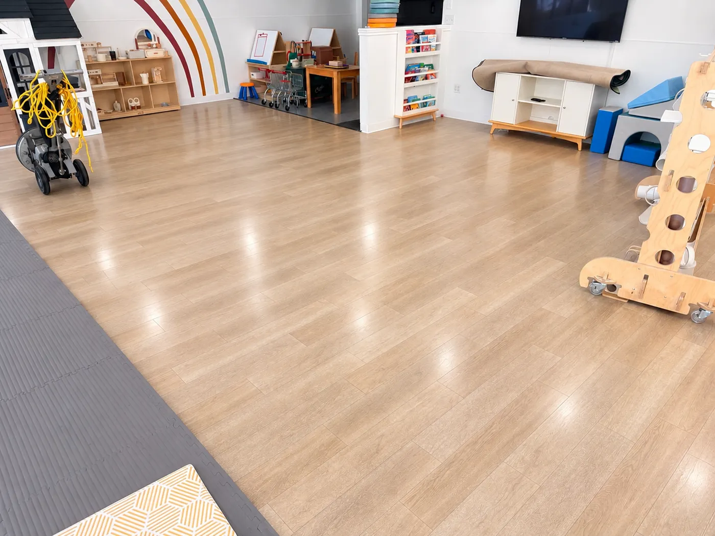 Main play room at Kids Inn Child Care Center in Southlake after daycare floor cleaning: shiny, clean vinyl plank