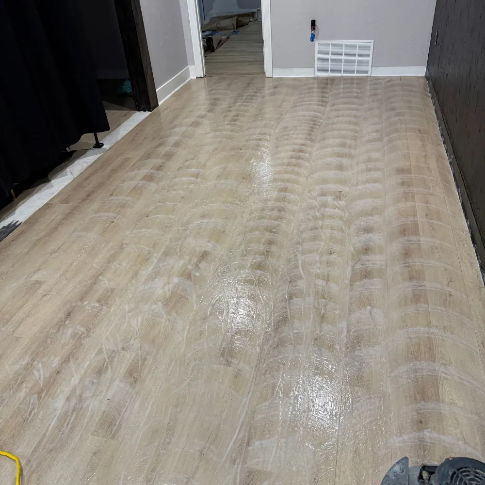 Luxury vinyl plank floor being scrubbed during cleaning