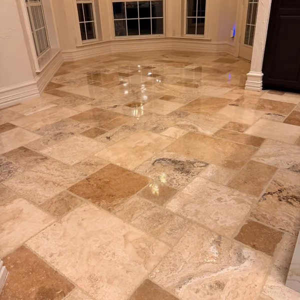 Polished travertine floor with a high shine in a room with bay windows
