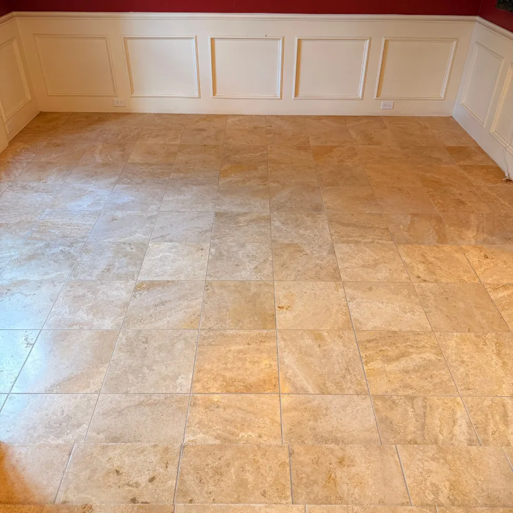 Travertine floor in a dining room with white wainscoting after cleaning