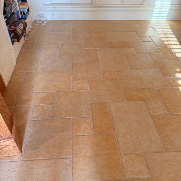 Tumbled stone floor beside built-in shelves after cleaning