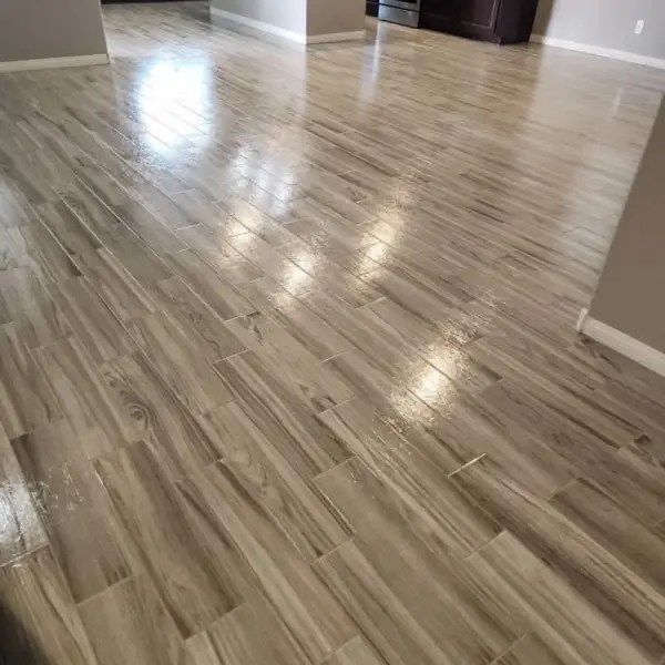 Clean wood-look tile floor with bright grout lines