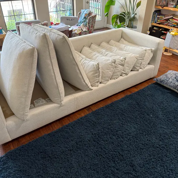 Sofa with cushions set out during upholstery cleaning before a listing in Colleyville