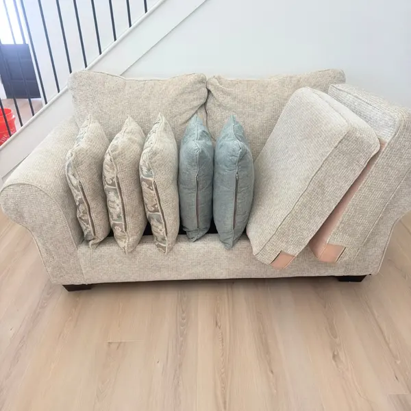 Loveseat with pillows and cushions set out during upholstery cleaning in Grapevine