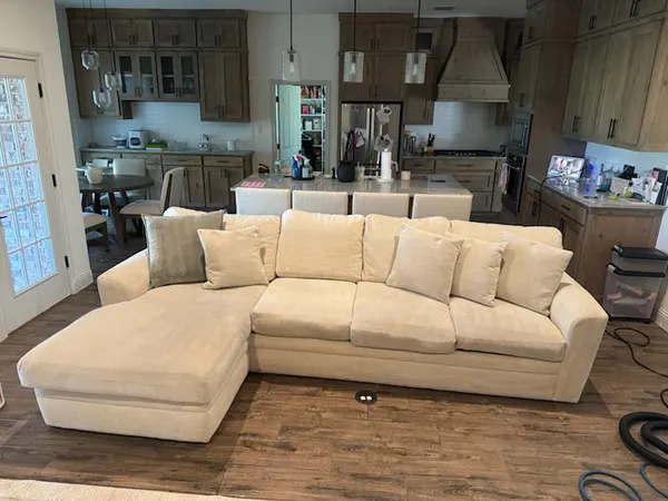 Cream sectional with chaise after upholstery cleaning in a Keller family room